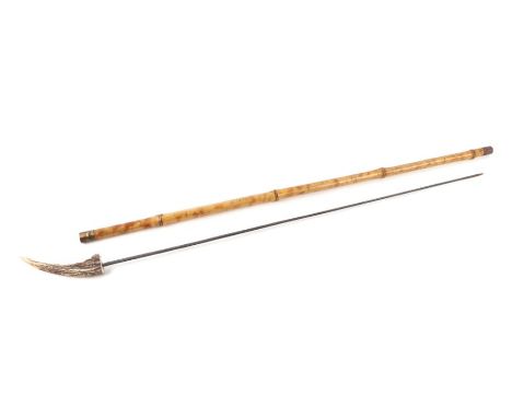 A cane shafted sword stick with a stag horn handle and having a 71cms (28.5ins) triangular section blade, no makers mark. Ove