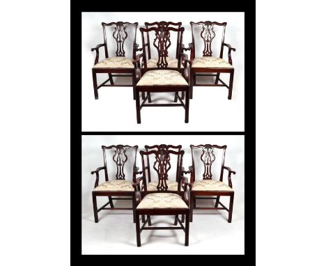 A matched set of eight Chippendale style mahogany carver dining chairs, each with pierced vase shaped back splats, drop-in se