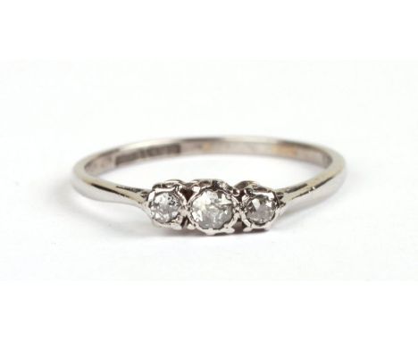 A platinum three-stone diamond ring, approx UK size 'Q', 2.6g.