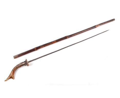 A cane shafted sword stick with a stag horn handle and having a 64cms triangular section blade, no makers mark. Overall lengt