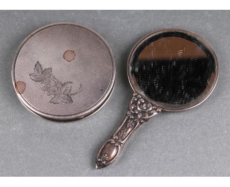 A silver circular compact with engine turned decoration, Birmingham 1979, 7cms diameter, 85g; together with a miniature hand 