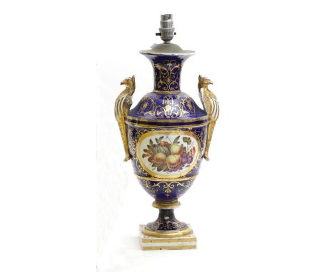 A 19th century English porcelain vase with griffin handles, the decoration depicting fruit on a blue ground with gilt highlig