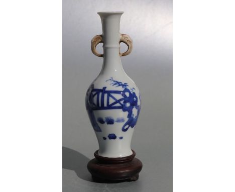 A Chinese blue &amp; white two-handled vase decorated with ladies in a garden with Artemisia leaf to the underside, on a hard