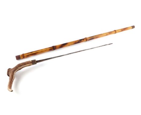 A bamboo shafted sword stick with a stag horn handle and having a 49cms (19.25ins) square section blade with an indistinct ma