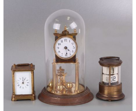 An Anniversary type clock under a glass dome, 30cms high; together with a Waterbury Clock Company carriage clock in a brass c