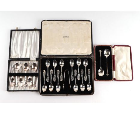 A cased set of twelve silver spoons and sugar tongs with pierced thistle decoration, Sheffield 1927; together with a pair of 