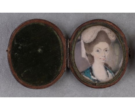 A late 18th century oval portrait miniature on ivory depicting a lady wearing a bonnet, 3.5 by 4cms, in a velvet lined shagre