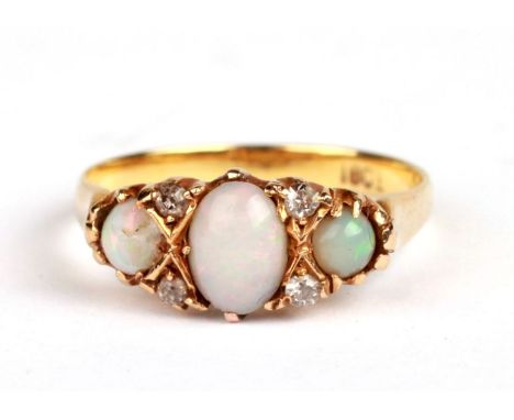 An 18ct gold opal and diamond ring, approx UK size 'M'.