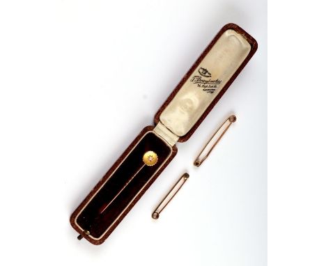 A Victorian 15ct gold pearl set stick pin, 1.3g, boxed; together with two 9ct gold tie pins, 4g.