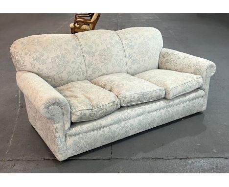 A country house style three-seater sofa with scroll arms and feather filled cushions, 190cms wide.Condition ReportThe colour 