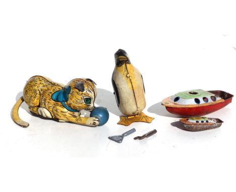 Three tinplate clockwork toys to include a Mar Toys cat playing with a ball, 12cms long; a penguin and two Pon-Pon boat, all 