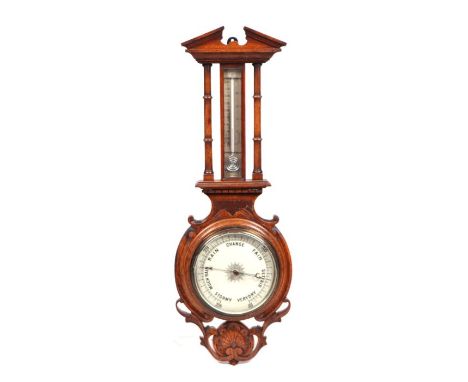 A late 19th century carved oak barometer thermometer.
