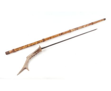 A cane shafted sword stick with a stag horn handle and having a 44.5cms (17.5ins) triangular section blade, no makers mark. O