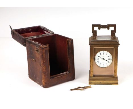A late 19th century French brass four-pillar carriage clock, the white dial with Roman and Arabic numerals, indistinctly sign