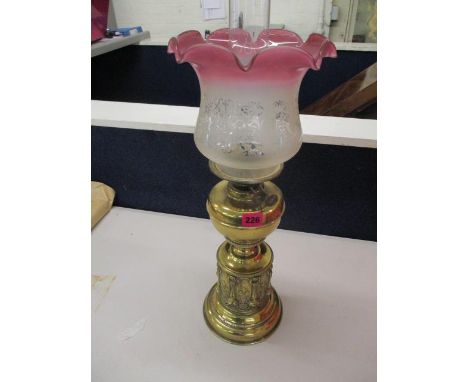 A Duplex Victorian, ornate brass oil lamp, with later etched and cranberry rimmed glass shade with a smoke funnel 