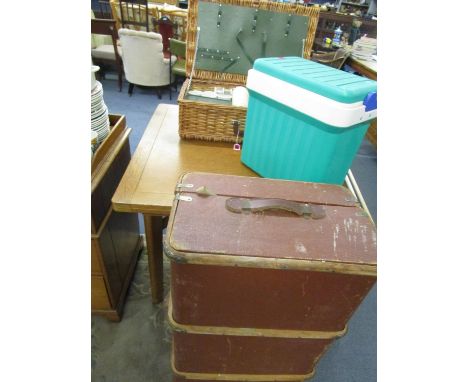 A wicker hamper containing a picnic set, a cool box and a canvas and wood travelling trunk 