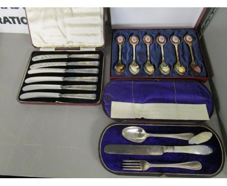 A cased set of six silver handled butter knives, Sheffield 1934, marked G H  for Harrison Brothers and Howson, a cased Christ