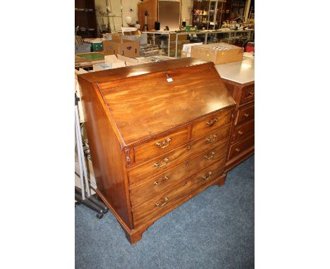 A GEORGIAN MAHOGANY FALL FRONT BUREAU, the fitted interior with various drawers and central cupboard, having two short over t