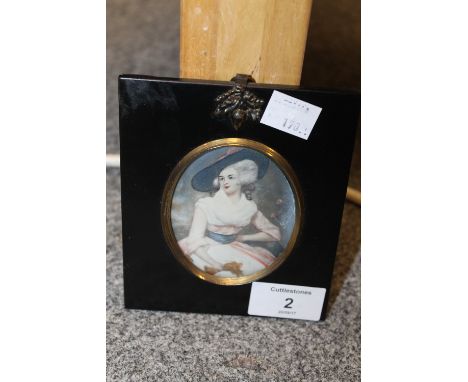 A 20TH CENTURY OVAL PORTRAIT MINIATURE ON IVORINE, woman with large hat and holding a pair of gloves, indistinctly signed mid