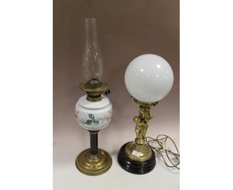 A BRASS FIGURATIVE TABLE LAMP + A FLORAL GLASS OIL LAMP  (2)