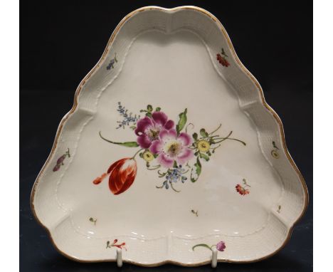 A Ludwigsburg porcelain triangular shaped dish, painted with a floral bouquet, 18cmCONDITION: Light wear to the rim gilding, 