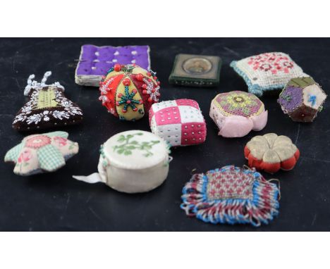 Twelve assorted 19th century fabric pin cushions including Irish silkwork, velvet and beadworkCONDITION: - Irish? white silk 