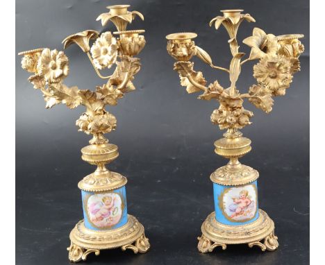 A pair of 19th century French ormolu and Sevres style porcelain three light candelabra, with lily, carnation and fruit moulde