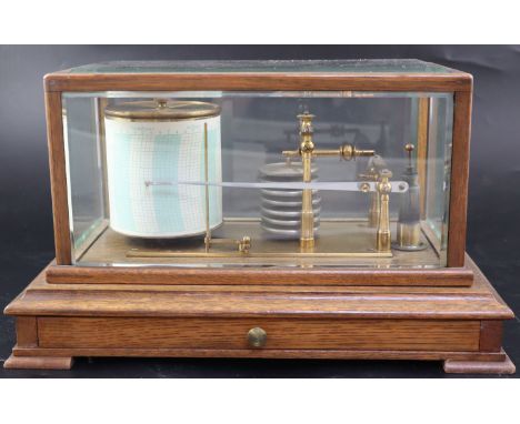 An Edwardian oak cased barograph, in bevelled glass case, with graph paper drawer, on bracket feet, width 36.5cm depth 22cm h