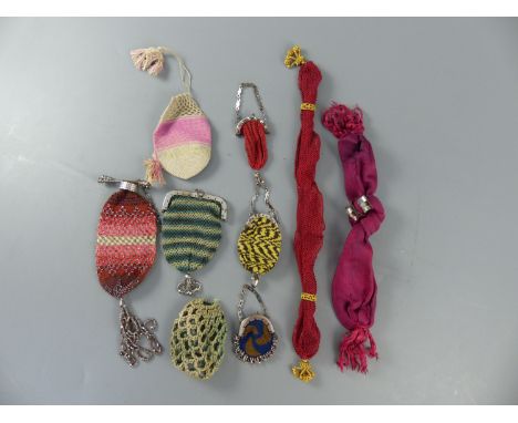 A group of assorted needlework and cut steel pursesCONDITION: - long puce fabric purse with two faceted cut steel rings, torn