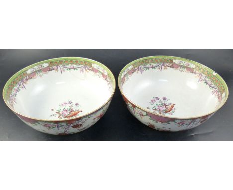 A pair of famille rose punch bowls, Qing dynasty, 18th century, painted with vases of flowers and floral swags, diameter 29cm