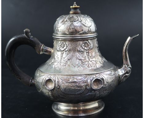 A late 18th/early 19th century Dutch embossed white metal pear shaped teapot, height 15.3cm, gross 10oz.CONDITION: Knop a rpe