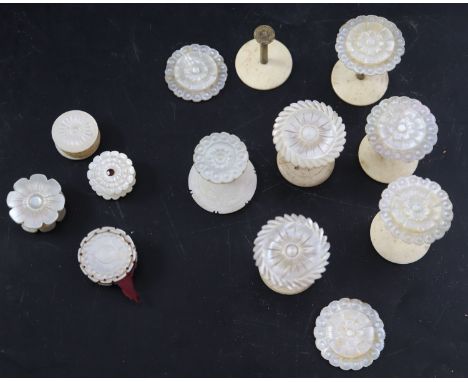A group of 19th century Palais Royale sewing accessories comprising: seven mother of pearl and bone reels, three wax reels an