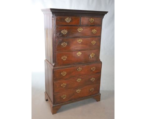 A George II mahogany chest on chest, with dentil moulded cornice over two short and three long drawers within fluted canted c
