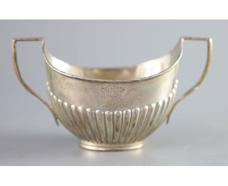 A Victorian demi fluted silver two handled oval sugar bowl, Edward Hutton, London 1893, width 15.2cm, 107 grams.CONDITION: En