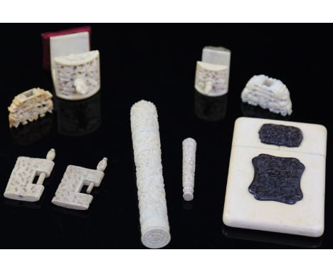 A group of 19th century Chinese carved ivory sewing accessories comprising: two pin cushion clamps, two other clamps, needlec