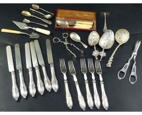 A collection of mixed silver flatware, including a 19th century cheese scoop, sifter spoon, grape shears, sugar nips, Victori