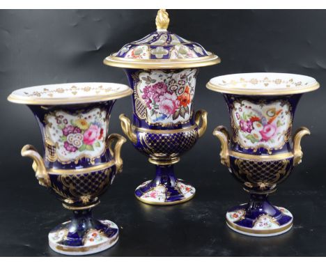 An English porcelain garniture of three vases, c.1830, each of two handled campana form, the central vase with a pierced dome