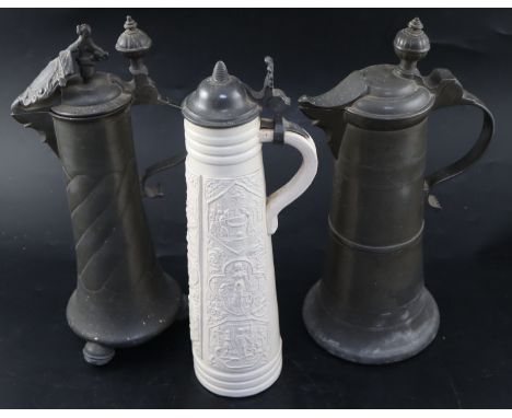 An 18th century Continental pewter flagon, initialled and dated 1777, height 35cm, a later flagon with crested lid dated 1798