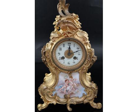 An early 20th century French gilt metal and porcelain eight day mantel clock, the arabic dial signed Aitchison, over a panel 