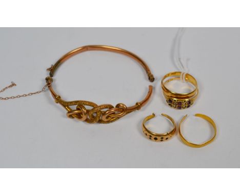 A 22 carat gold band ring, finger size S, another 22 carat gold band ring, shank cut, a 15 carat gold gem set ring, finger si