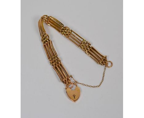 A gate link bracelet with padlock clasp, length 19.5cm.  Padlock clasp stamped '9CT'. Gross weight 13.0 grams. 