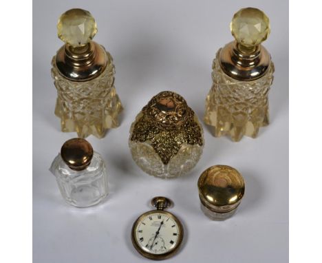 A pair of silver mounted cut glass scent bottles, three other silver mounted scent bottles, a silver pocket watch signed John