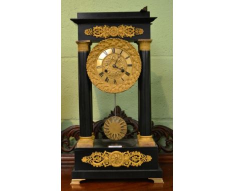 An ebonised and gilt metal mounted portico striking mantel clock, first part of the 19th century 
