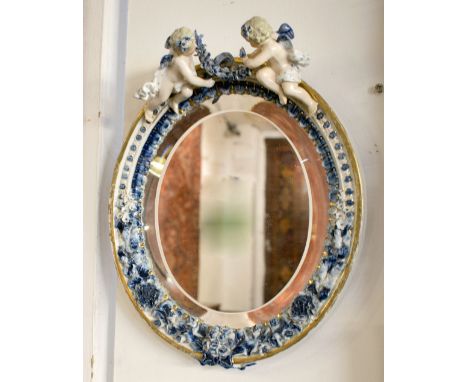 LOOKING GLASS, Meissen style ceramic with cherub mounted frame bevelled oval plate, 33cm H x 25.5cm W overall.