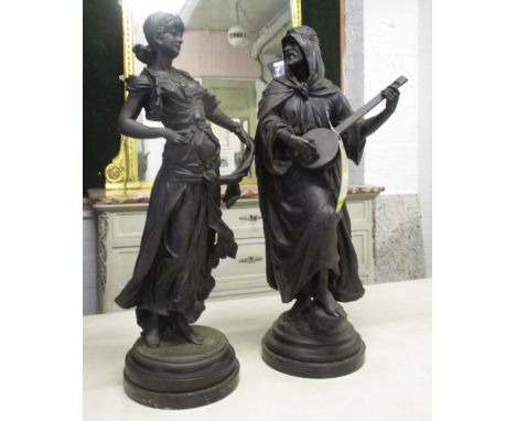 SPELTER FIGURES, two, one of a dancing maiden, the other of an Arab gentleman playing the lute, both approx, 66cm H. (2)