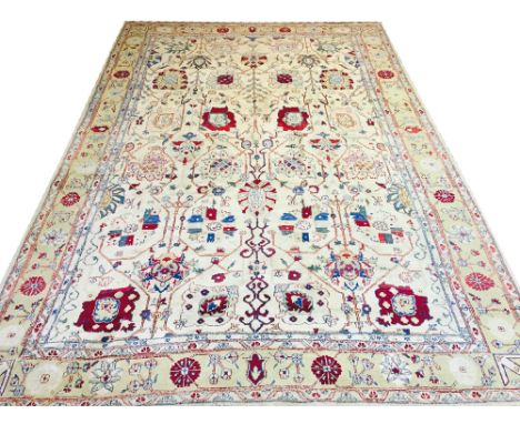 FINE AGRA DESIGN CARPET, 436cm x 297cm, all over stylised palmette and vine design within corresponding bands and borders.