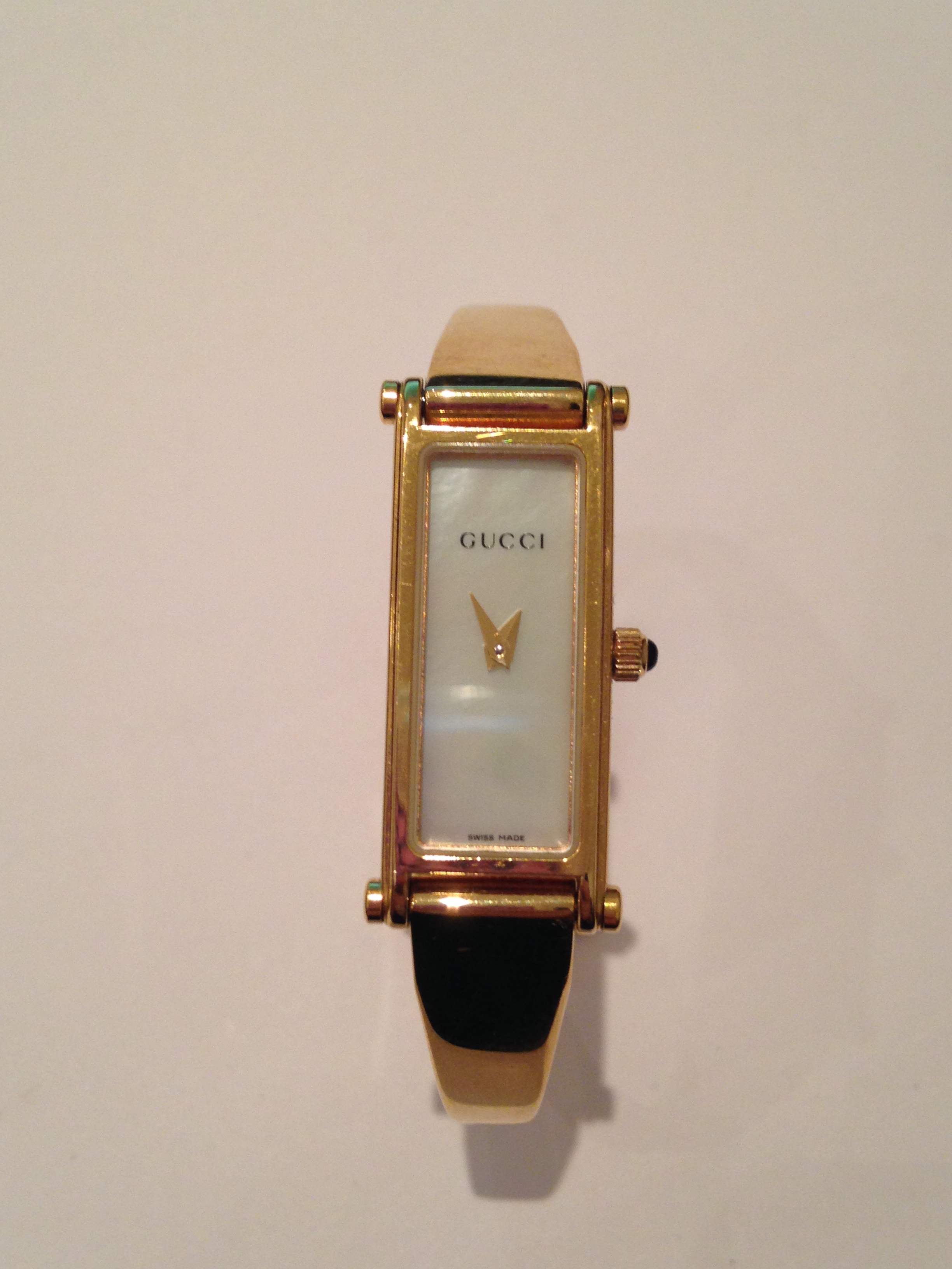 Preowned ladies Gucci watch, 1500L series. Stainless steel with gold plating. Rectangular face