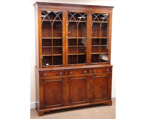 Bevan Funnell Reprodux mahogany bookcase on cupboard, three glazed doors enclosing nine adjustable shelves above three drawer