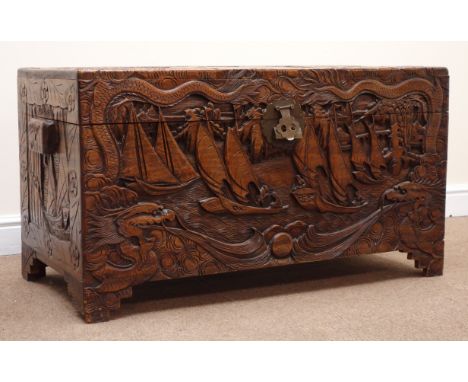 Early 20th century camphor wood chest, hinged lid with clasp and stay, heavily carved depicting with ships and dragons, shape