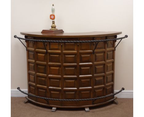 Spanish style walnut and beech panelled bow fronted bar, metal rope twist foot and hand bar, fitted single hand pump, W170cm,